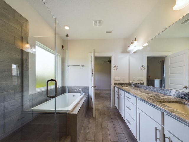 full bathroom with vanity, toilet, and separate shower and tub