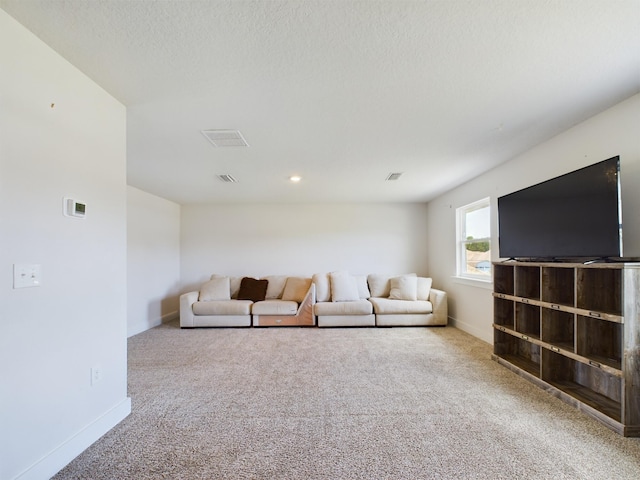 unfurnished living room featuring carpet flooring and a textured ceiling