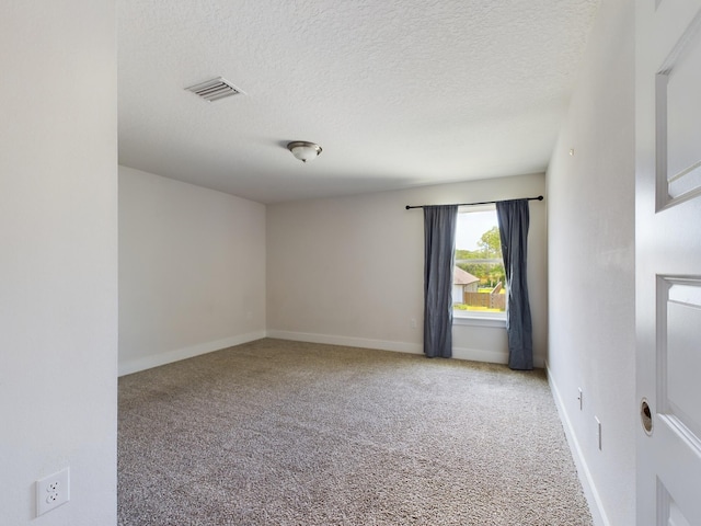 carpeted spare room featuring a textured ceiling