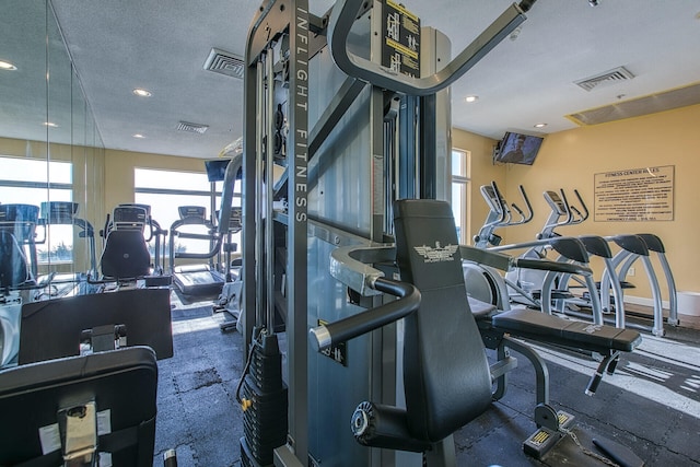 exercise room featuring a textured ceiling