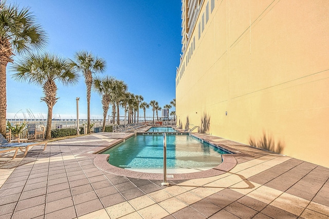 view of pool with an in ground hot tub and a patio