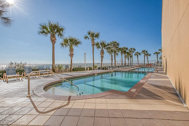 view of pool with a jacuzzi and a patio