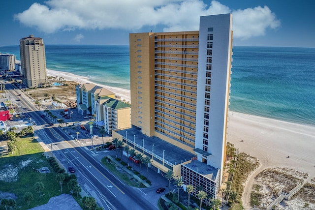 bird's eye view featuring a water view and a beach view