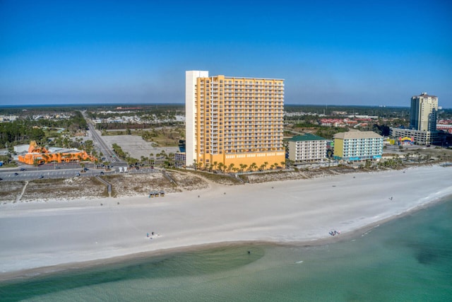 drone / aerial view featuring a water view and a beach view