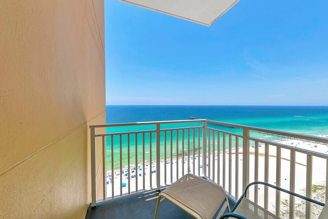 balcony featuring a water view and a view of the beach