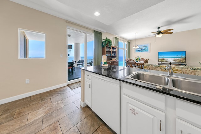 kitchen with white cabinets, plenty of natural light, white dishwasher, and hanging light fixtures