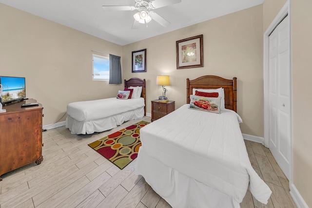 bedroom featuring ceiling fan, light hardwood / wood-style flooring, and a closet