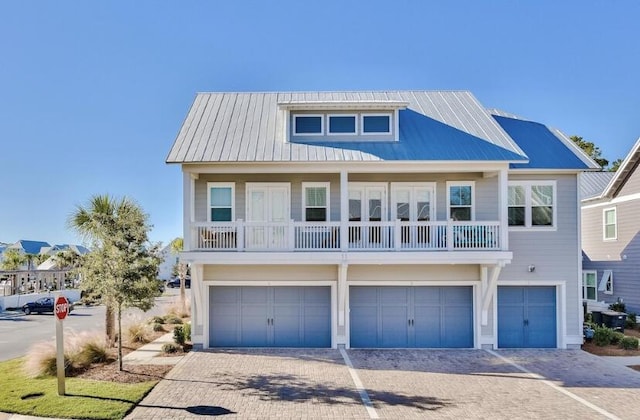 view of front of house featuring a garage and a balcony