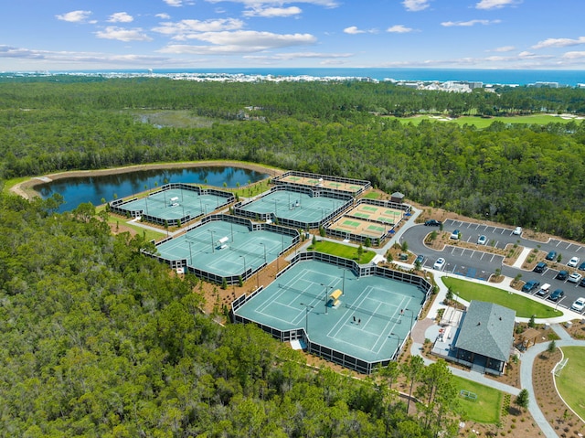 aerial view with a forest view and a water view