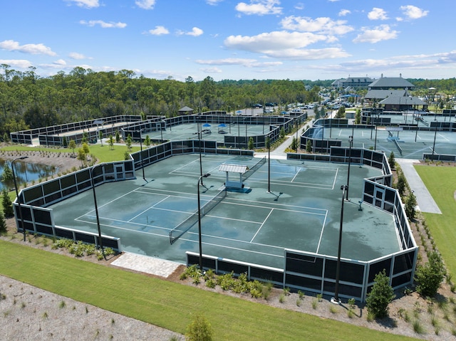 view of tennis court with a water view