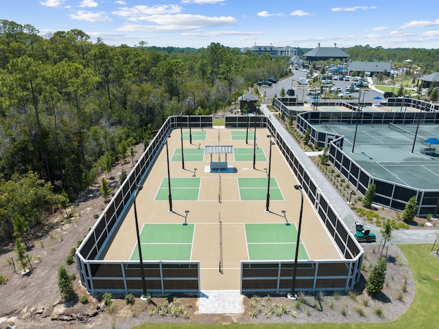 exterior space featuring a tennis court and fence