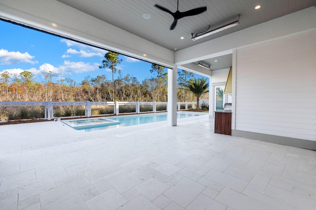 view of swimming pool with ceiling fan and an in ground hot tub