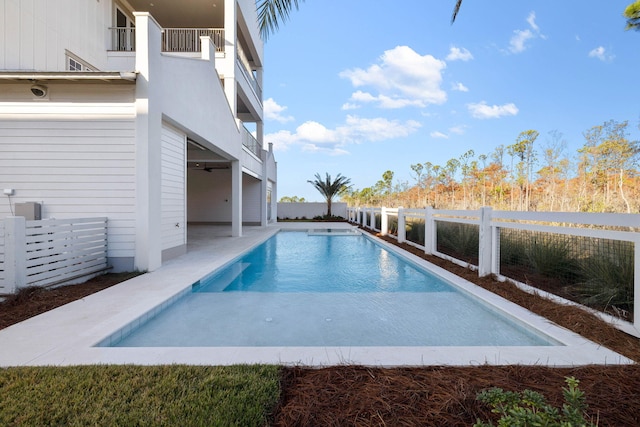 view of pool featuring ceiling fan and a patio area