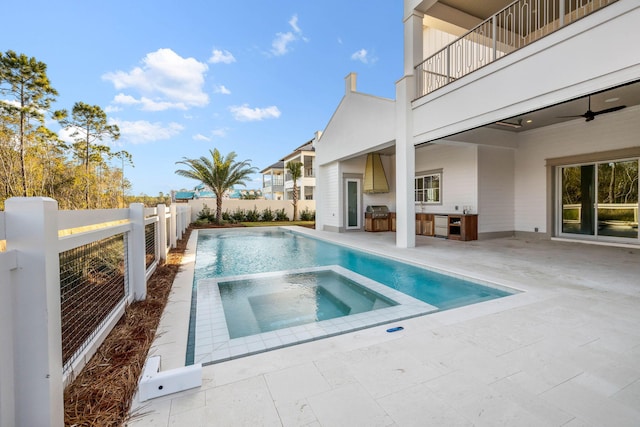 view of swimming pool featuring an in ground hot tub, a patio, ceiling fan, and grilling area