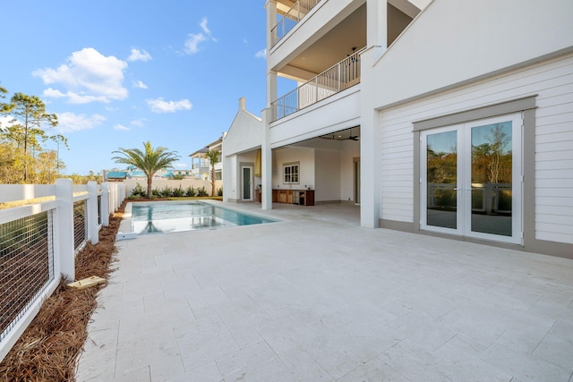 view of swimming pool with a patio area and french doors