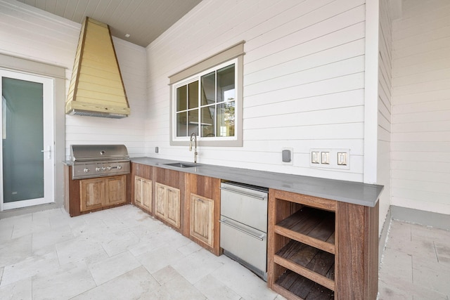 kitchen with sink, white refrigerator, wood walls, and custom exhaust hood