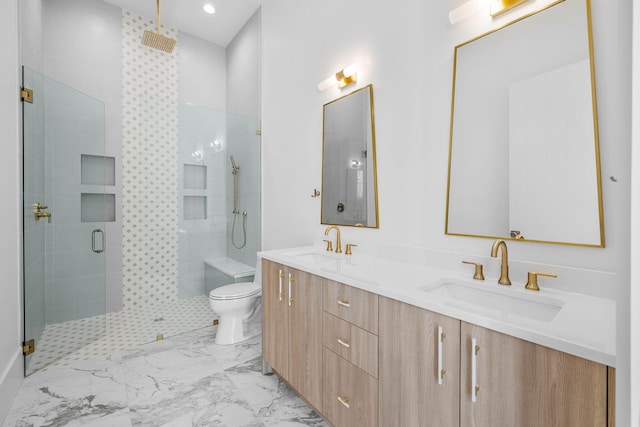 bathroom featuring vanity, toilet, and a shower with door