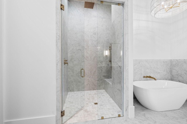 bathroom with shower with separate bathtub and tile walls