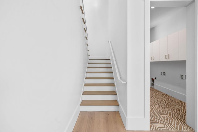 stairs with hardwood / wood-style floors