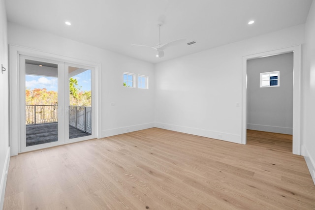 empty room featuring light hardwood / wood-style floors, ceiling fan, and a healthy amount of sunlight