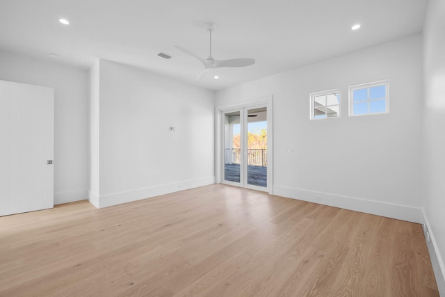 spare room featuring light hardwood / wood-style floors and ceiling fan