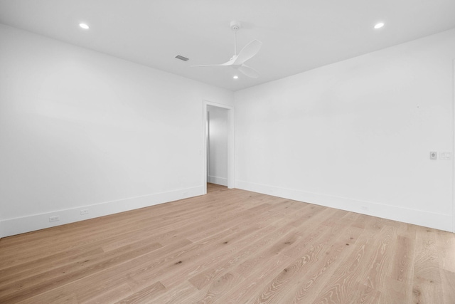 empty room featuring ceiling fan and light hardwood / wood-style flooring