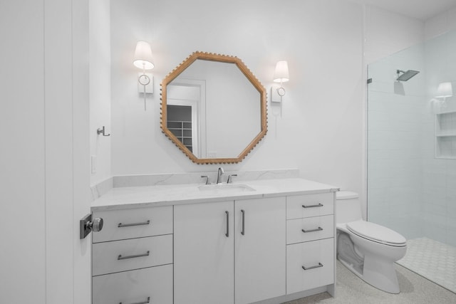 bathroom featuring toilet, vanity, and walk in shower