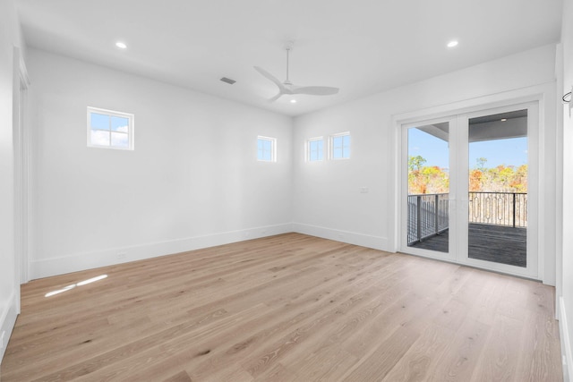 empty room featuring ceiling fan and light hardwood / wood-style flooring