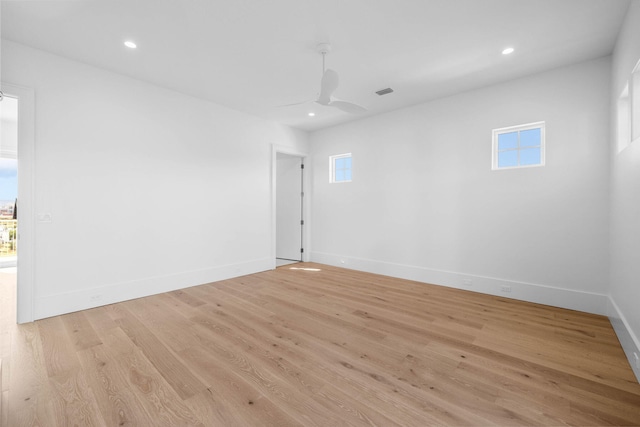 empty room with ceiling fan and light hardwood / wood-style floors