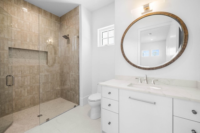 bathroom featuring tile patterned flooring, vanity, toilet, and a shower with shower door