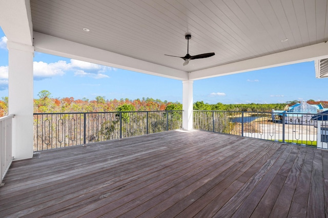 wooden deck with ceiling fan and a water view