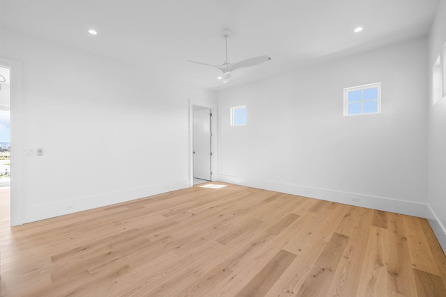 unfurnished room with ceiling fan and light wood-type flooring