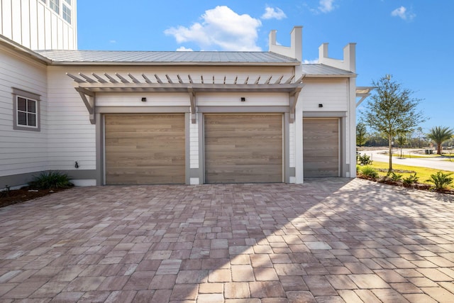 garage with decorative driveway