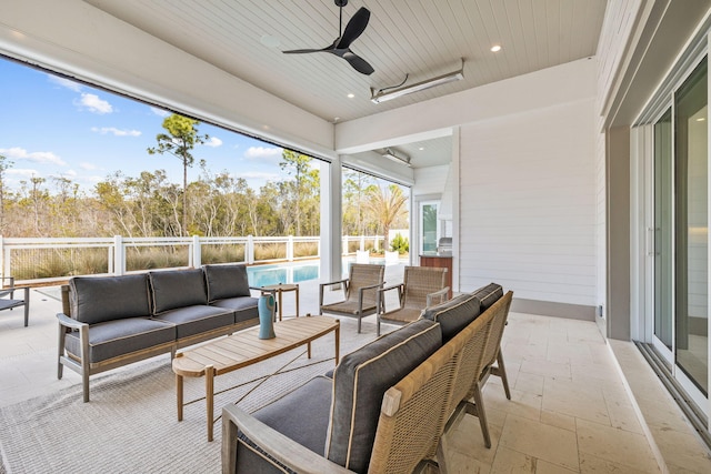 sunroom / solarium with wood ceiling and a ceiling fan