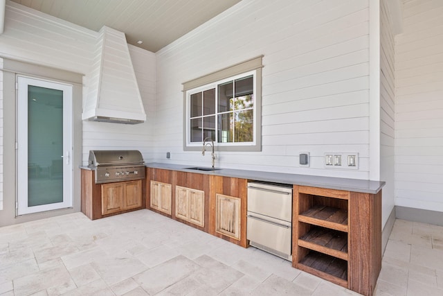 view of patio / terrace with an outdoor kitchen, grilling area, and a sink