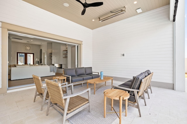 view of patio with an outdoor living space and a ceiling fan