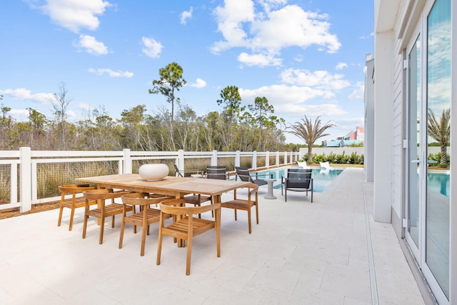 view of patio featuring a fenced in pool and outdoor dining area