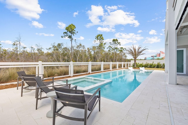 view of pool featuring a pool with connected hot tub, a patio area, and fence