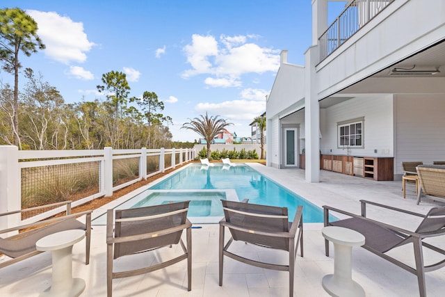 view of pool with an in ground hot tub, a patio area, a fenced backyard, and a fenced in pool