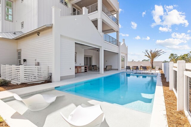 view of swimming pool featuring a patio, outdoor dining area, a fenced backyard, and a fenced in pool