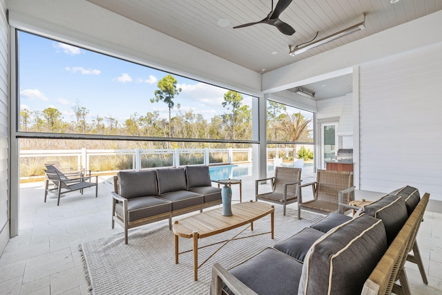 sunroom featuring wood ceiling and ceiling fan