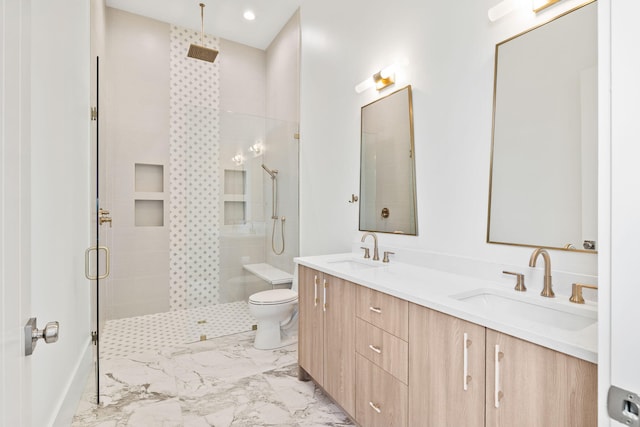 full bathroom featuring double vanity, marble finish floor, a sink, and tiled shower