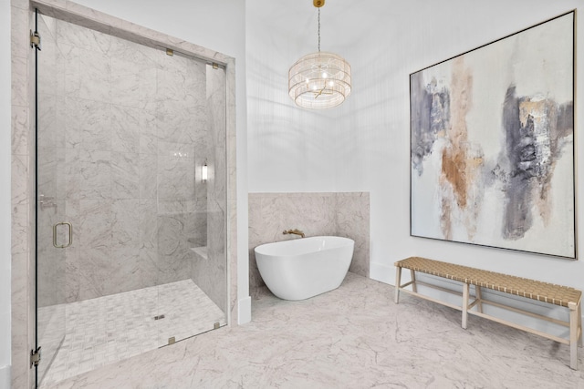 bathroom featuring a stall shower, marble finish floor, and a freestanding bath