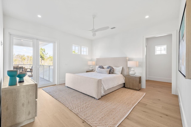 bedroom with baseboards, light wood-type flooring, visible vents, and access to exterior