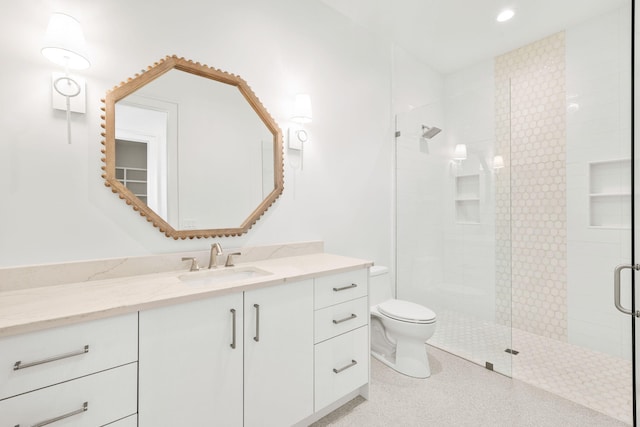 bathroom featuring toilet, tile patterned flooring, vanity, a shower stall, and recessed lighting