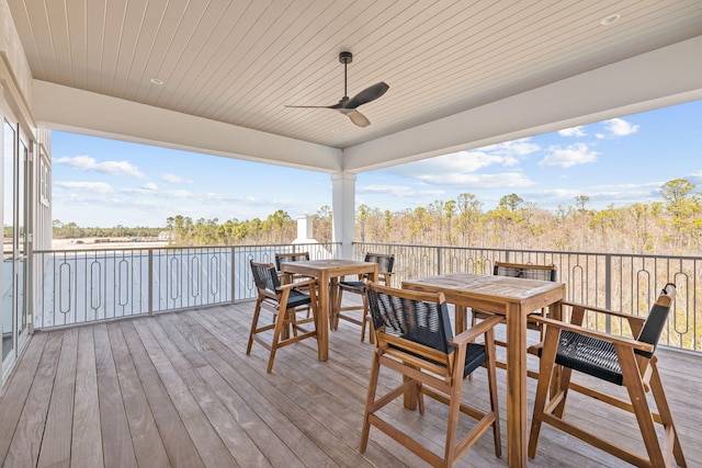 wooden terrace with ceiling fan and outdoor dining area