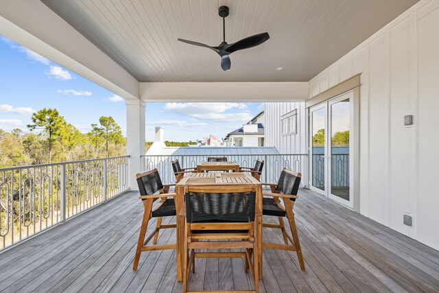 deck with outdoor dining area and ceiling fan