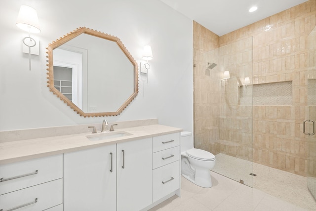 full bathroom with tiled shower, vanity, toilet, and tile patterned floors