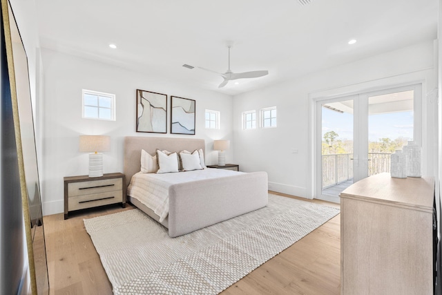 bedroom featuring light wood-type flooring, access to exterior, multiple windows, and french doors