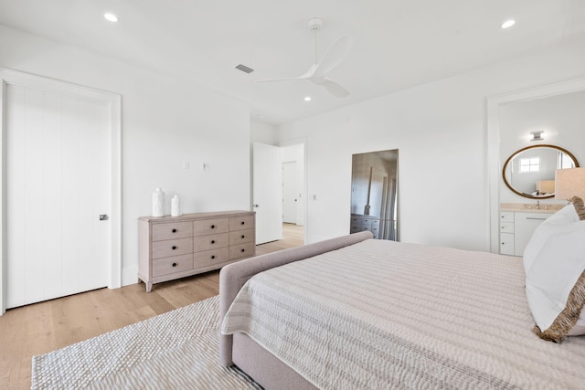 bedroom with ensuite bathroom, recessed lighting, a ceiling fan, visible vents, and light wood finished floors